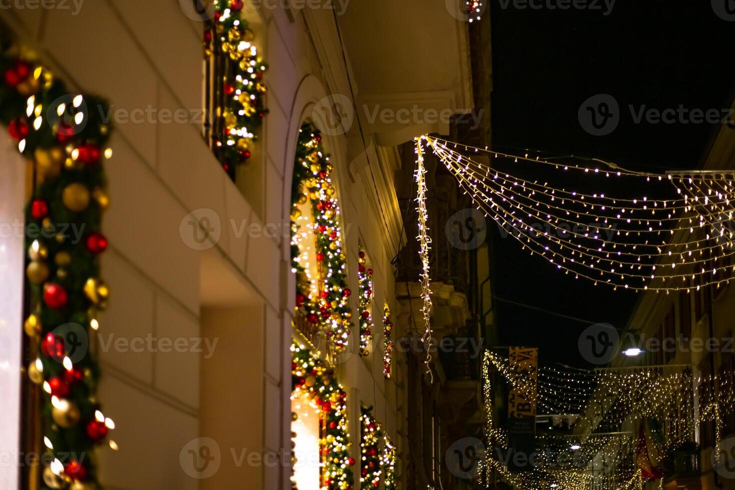 Fashion district Monte Napoleone District, quadrilatero della moda. Christmas shop windows of famous fashion brands on the evening street Monte Napoleone. 5.12.2023 photo