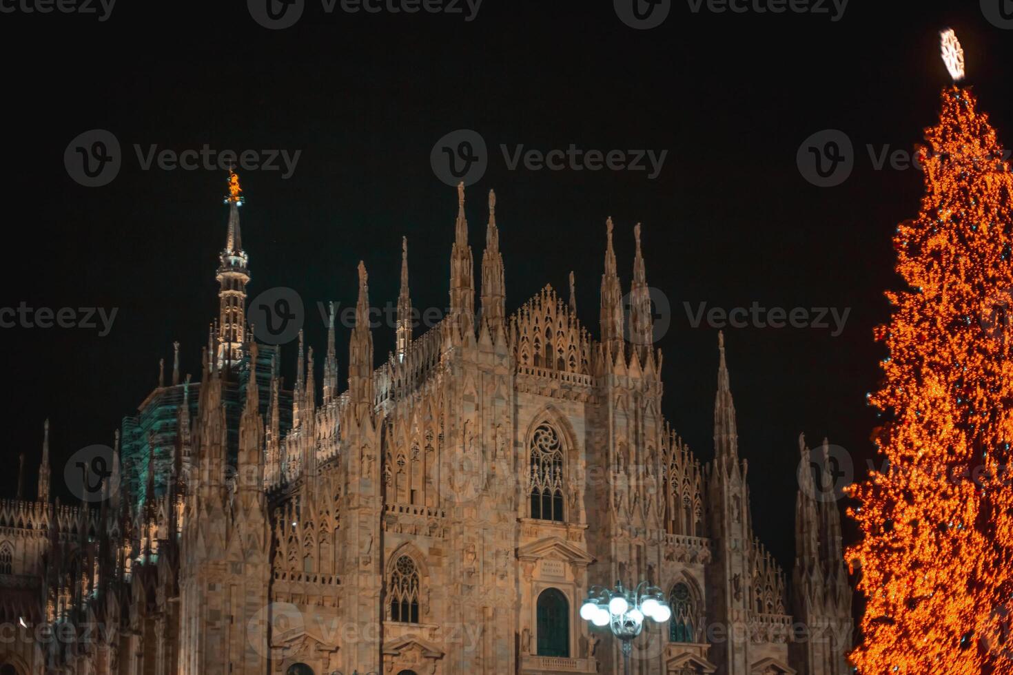 Milan, Italy 18.12.2023 in winter. Christmas tree in front of Milan cathedral, Duomo square in december, evening view. Christmas holidays in Milan. Christmas and New Year concept photo