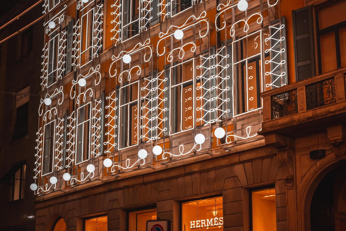 Christmas street of evening Milan. Montenapoleone District. Street and shops decorated with glowing garlands during the Christmas and New Year holidays in Milan, Italy 4.12.2023 photo
