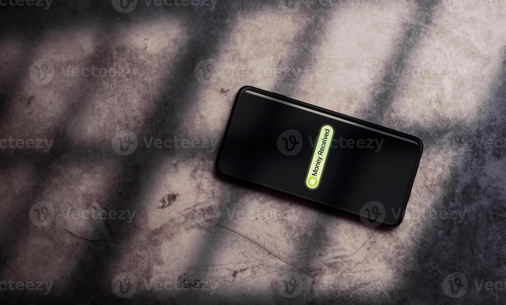 Desk top view of smartphone with money transfer on screen. Payment received. Online banking. Mobile applications to send and receive money on digital devices. photo
