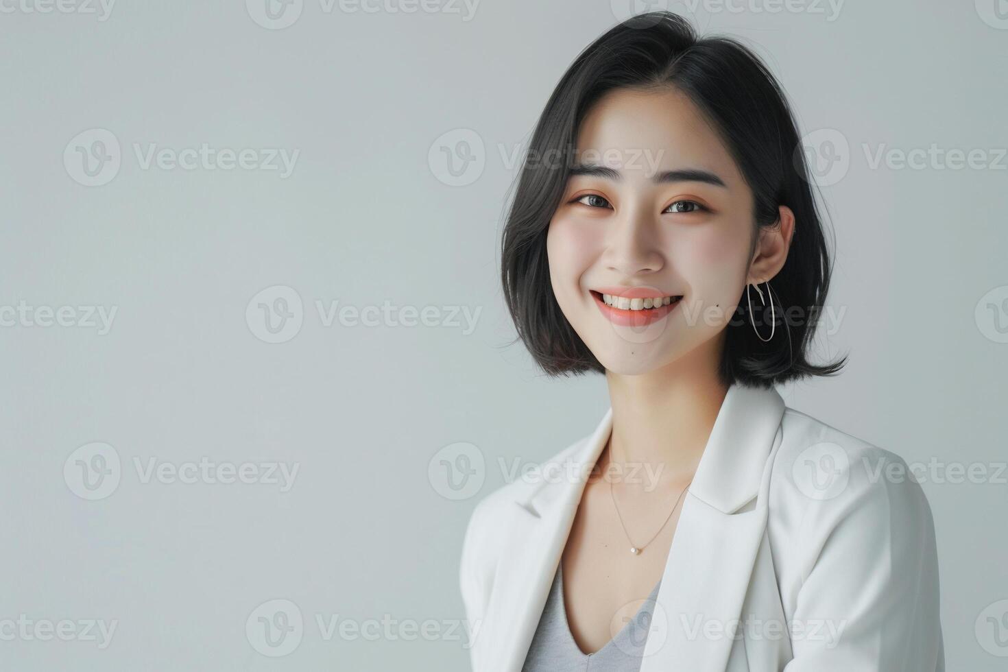 AI generated a confident young lady wearing white blazer smiling lively in isolated plain studio background photo