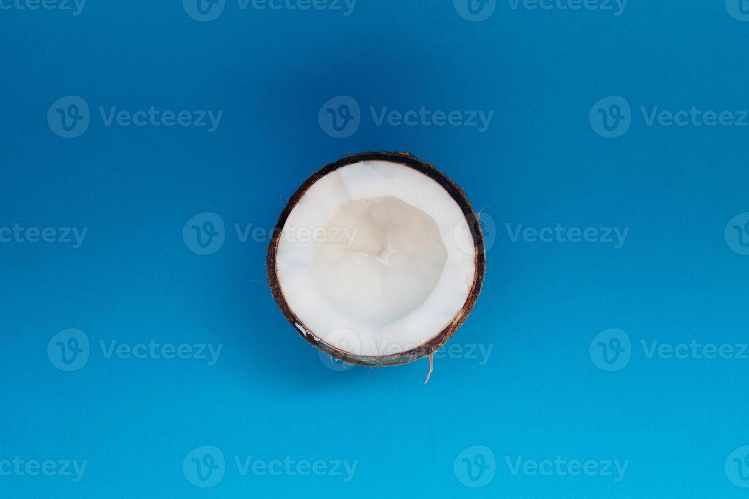 half Coconut isolated on blue Background. Clipping Path photo