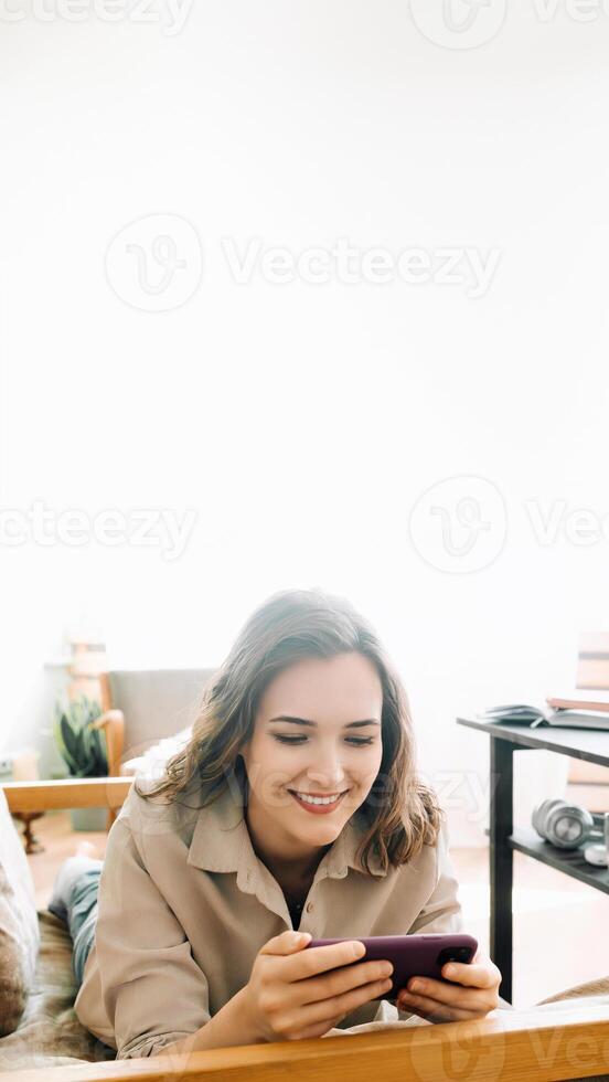 Joyful Woman Engaging with Smartphone. Reading Messages, Socializing on Social Media, and Playing Mobile Games. Happy Young Female Embracing Digital Interaction and Entertainment on Mobile Device photo