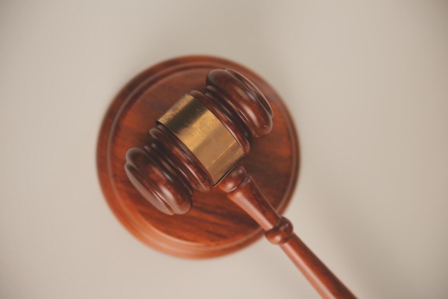 image of judge's hammer, scales lady of justice, law book, laptop computer and contract documents with pen concept of law and justice. photo