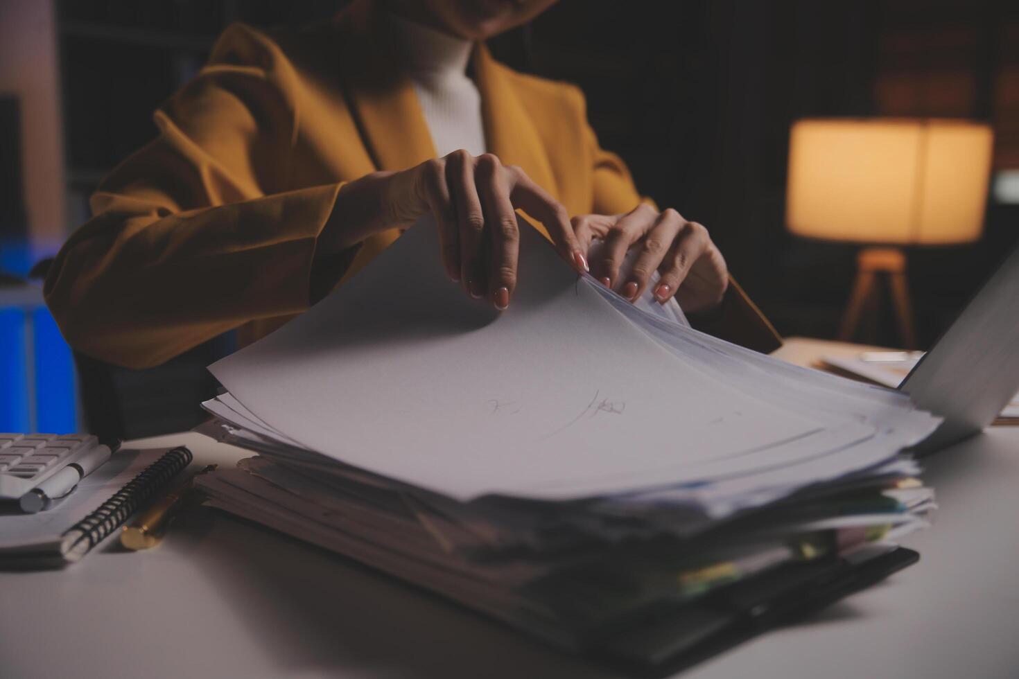 Business woman using calculator for do math finance on wooden desk in office and business working background, tax, accounting, statistics and analytic research concept photo