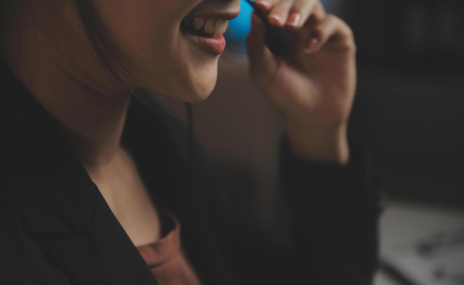 Young woman working in call centre, surrounded by colleagues photo