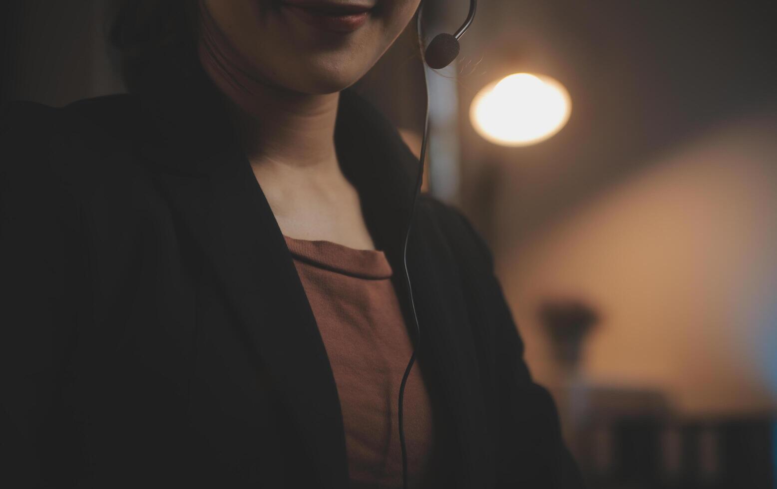 Young woman working in call centre, surrounded by colleagues photo