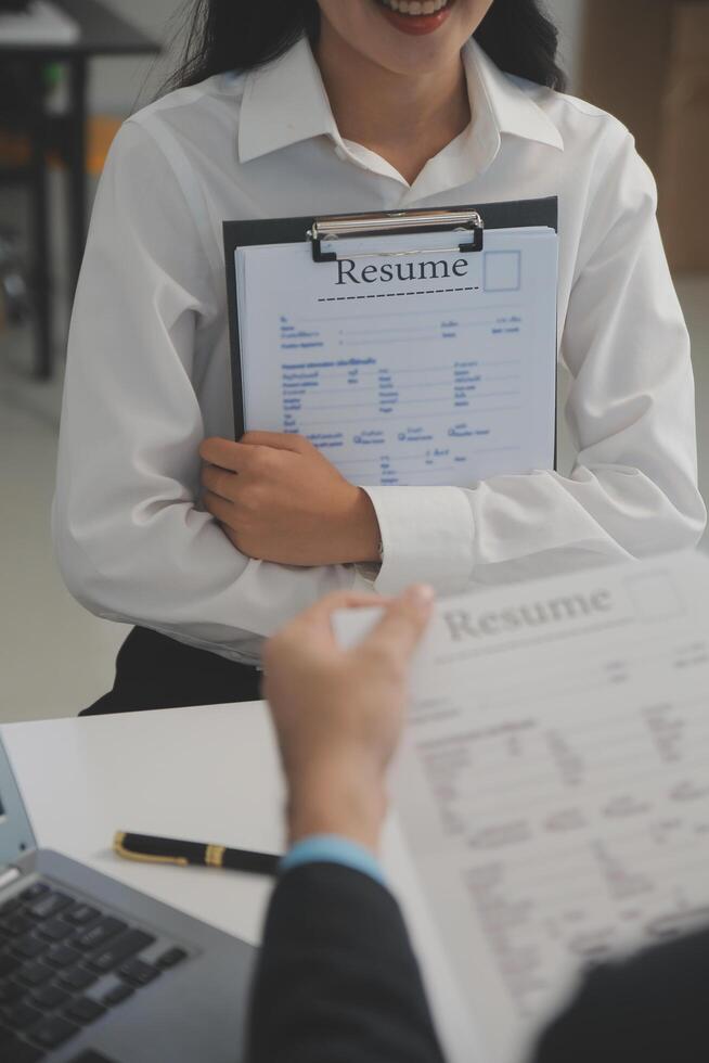 Close up view of job interview in office, focus on resume writing tips, employer reviewing good cv of prepared skilled applicant, recruiter considering application, hr manager making hiring decision photo