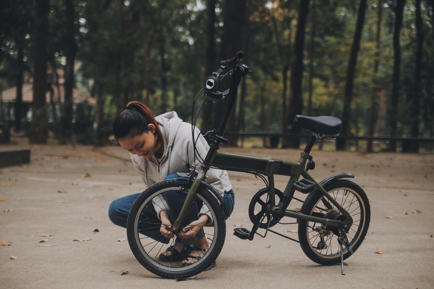 Happy Asian young woman walk and ride bicycle in park, street city her smiling using bike of transportation, ECO friendly, People lifestyle concept. photo