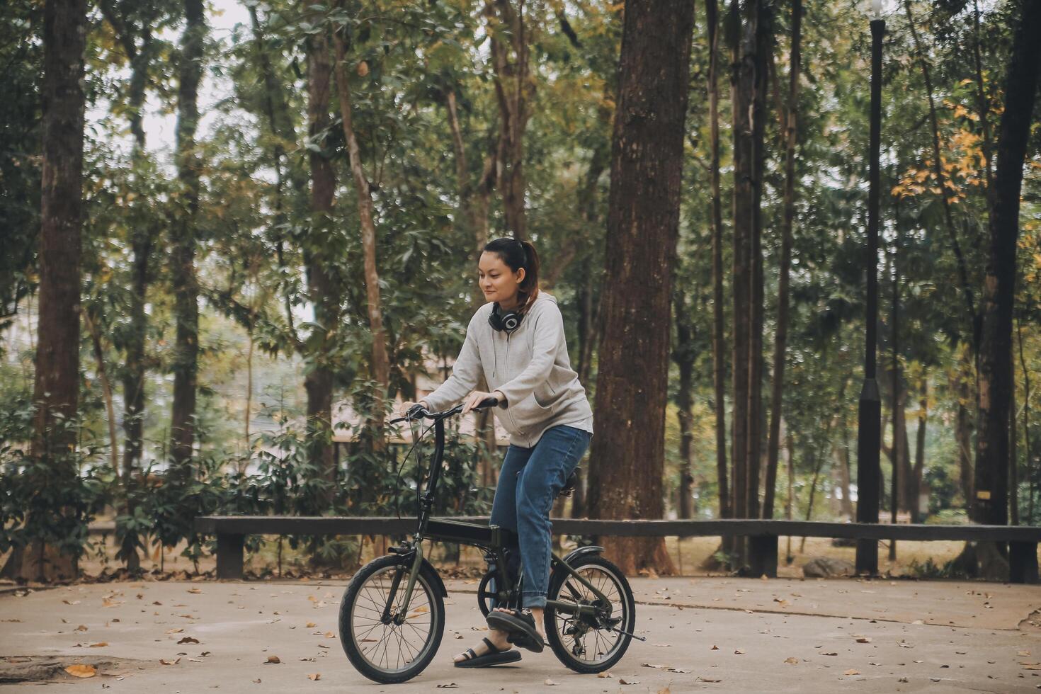 Happy Asian young woman walk and ride bicycle in park, street city her smiling using bike of transportation, ECO friendly, People lifestyle concept. photo