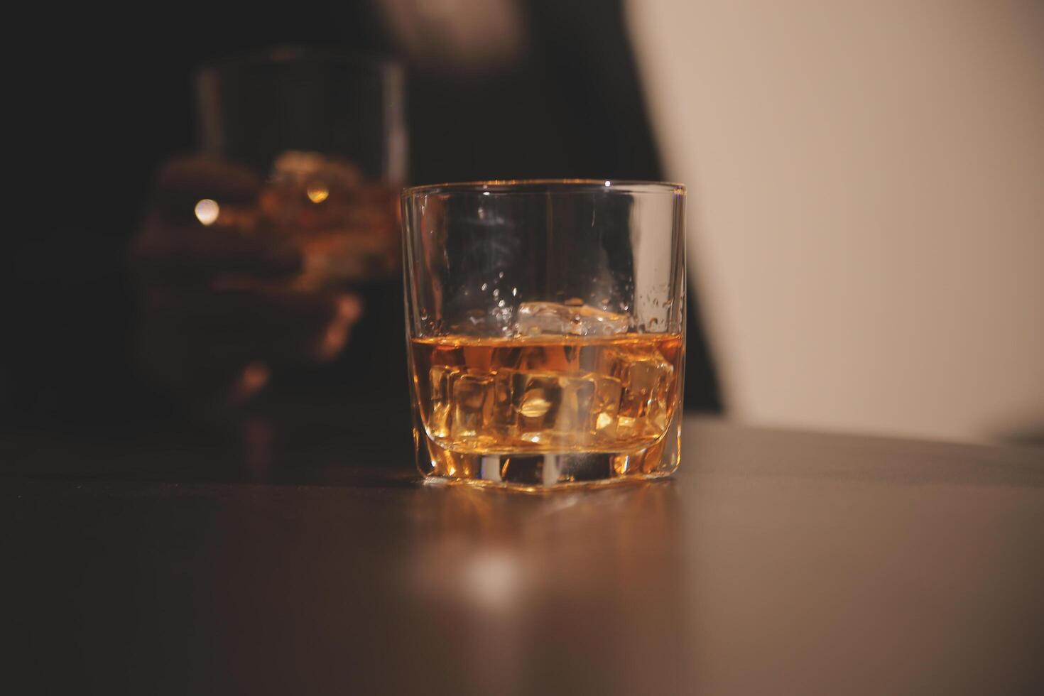 Celebration night, pour whiskey into a glass. Give to friends who come to celebrate photo
