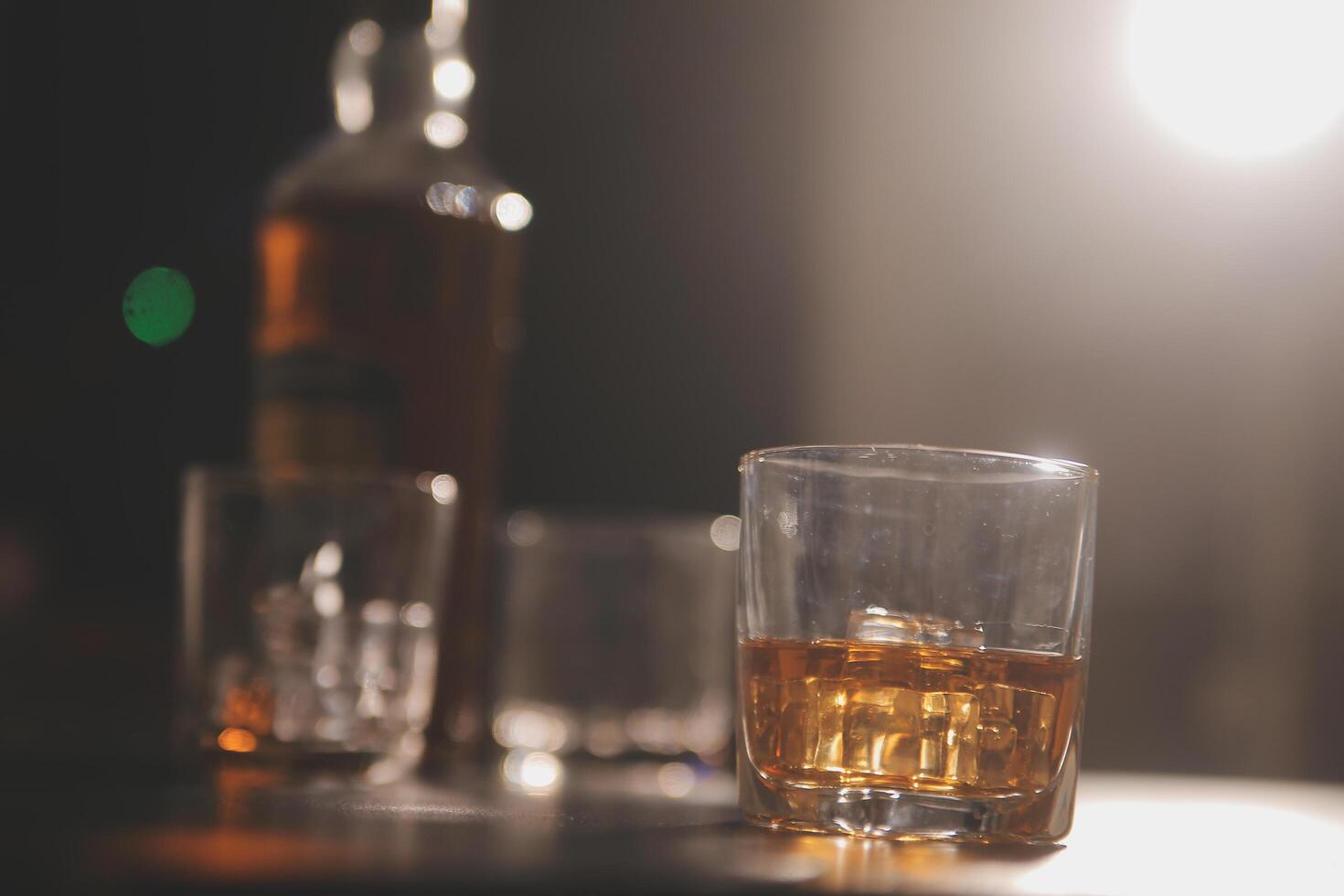 Celebration night, pour whiskey into a glass. Give to friends who come to celebrate photo
