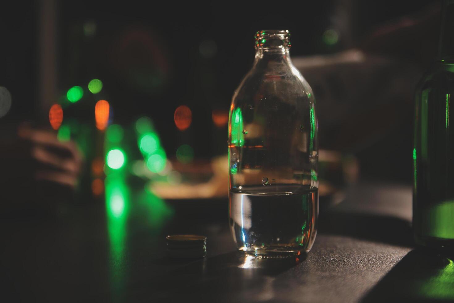 Celebration night, pour whiskey into a glass. Give to friends who come to celebrate photo