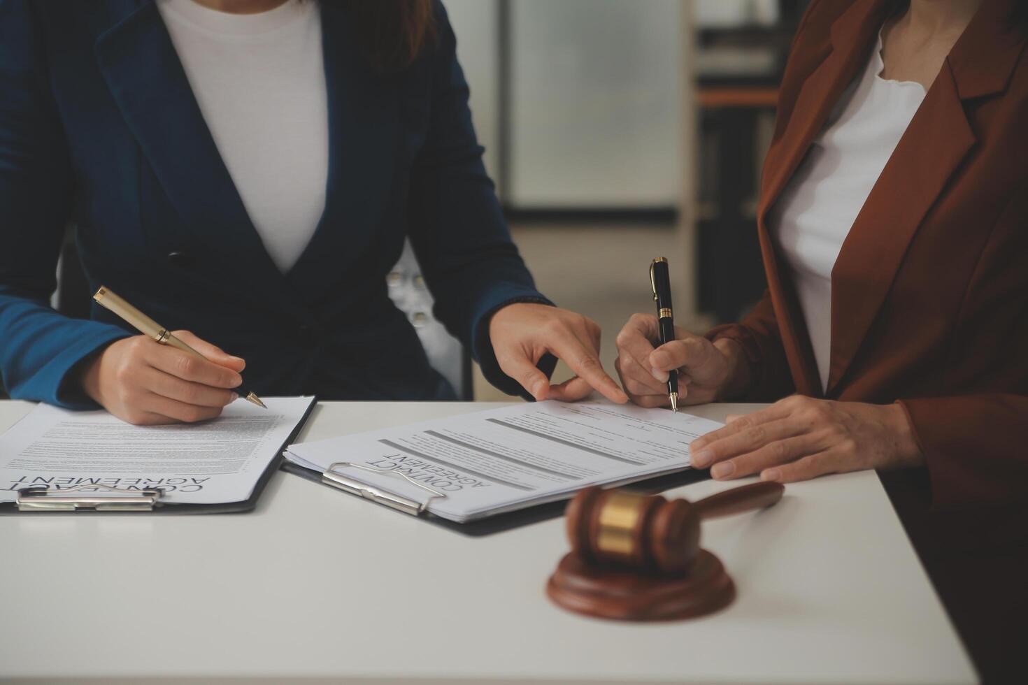 Lawyer, legal advisor, businessman brainstorming information on agreement details Business contracts in legal processing books for accuracy in contract documents. joint financial investment. photo