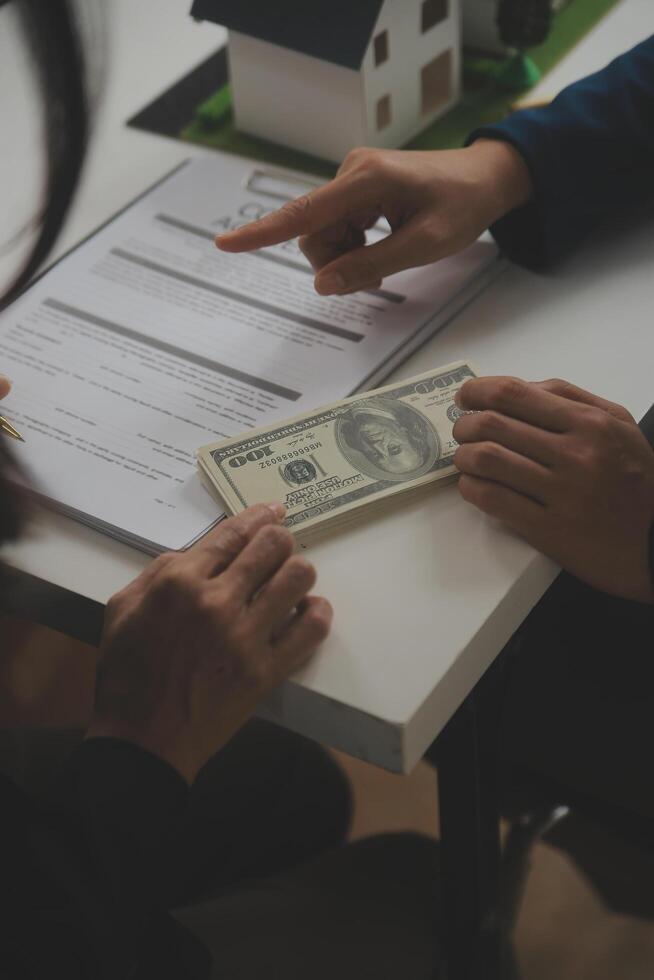 Business Signing a Contract Buy - sell house, insurance agent analyzing about home investment loan Real Estate concept. photo