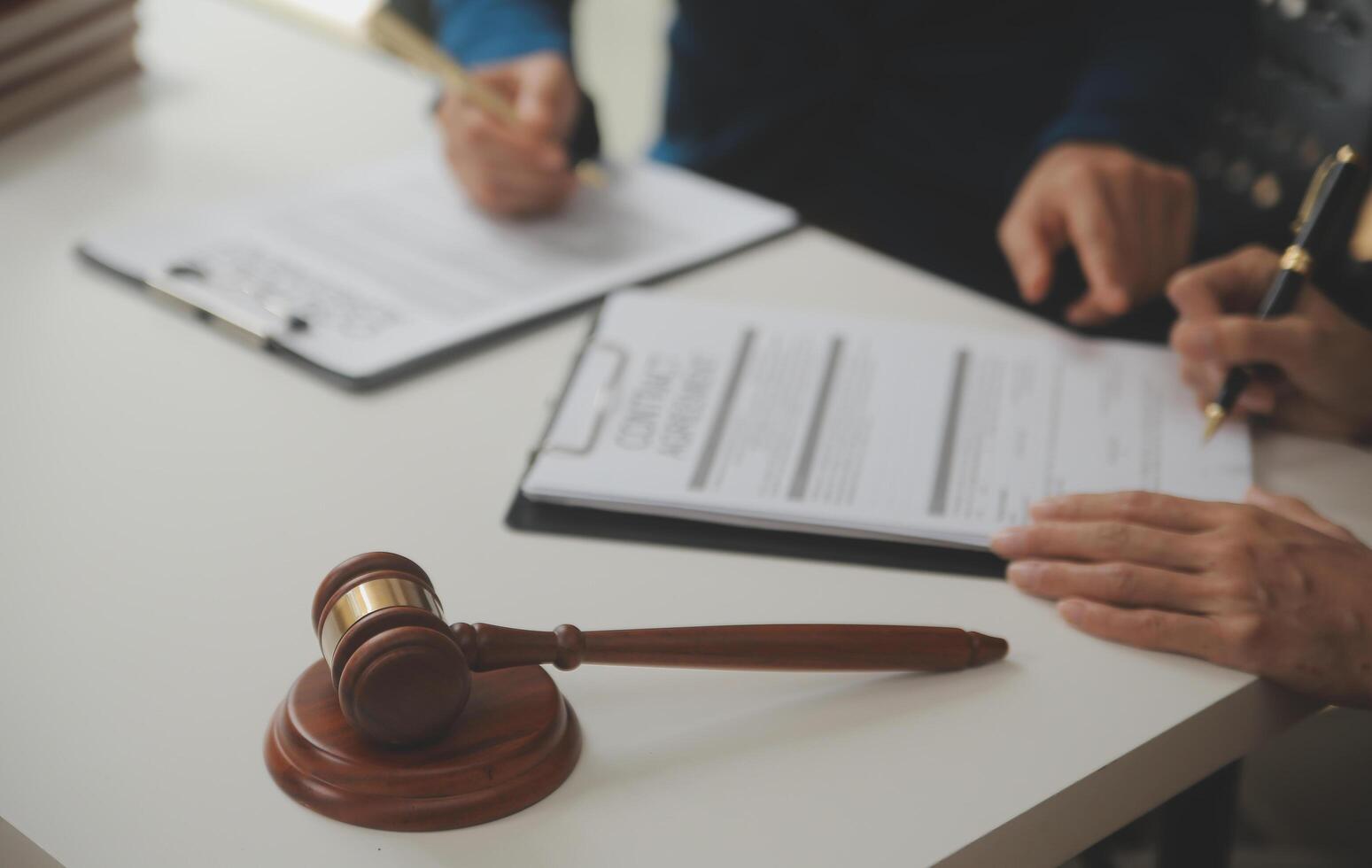 Lawyer, legal advisor, businessman brainstorming information on agreement details Business contracts in legal processing books for accuracy in contract documents. joint financial investment. photo