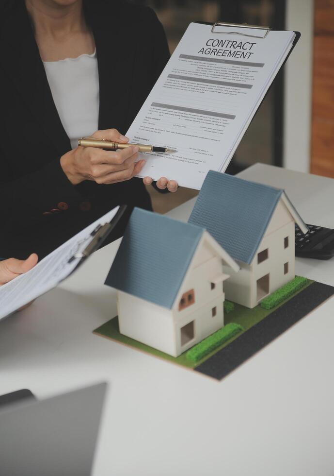 Business Signing a Contract Buy - sell house, insurance agent analyzing about home investment loan Real Estate concept. photo
