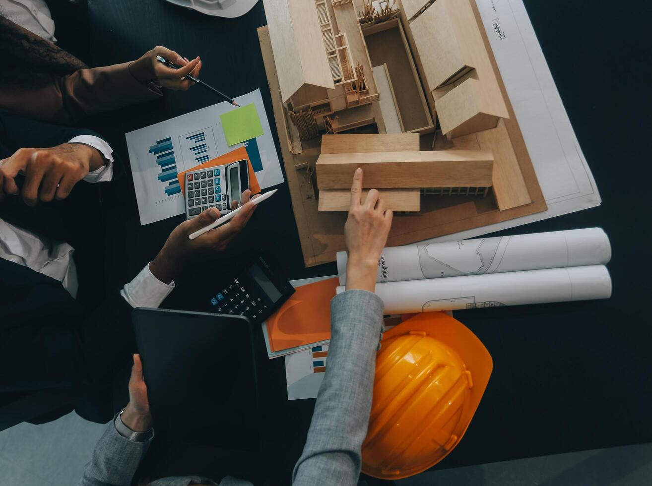 reunión de trabajo en equipo de ingenieros, trabajo de dibujo en la reunión de planos para el trabajo del proyecto con un socio en la construcción de modelos y herramientas de ingeniería en el concepto de sitio de trabajo, construcción y estructura. foto