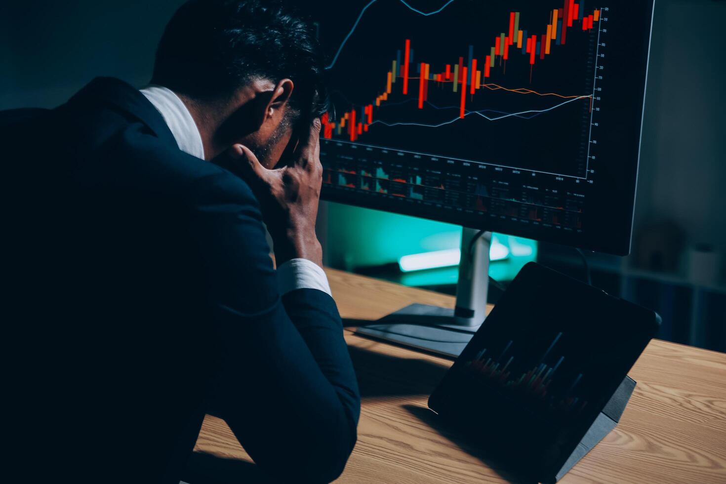 Thoughtful focused successful caucasian male stock investor, broker, financial adviser, sits at work desk, looks at computer, pensively analyze risks and prospects, rise or fall of cryptocurrency coin photo