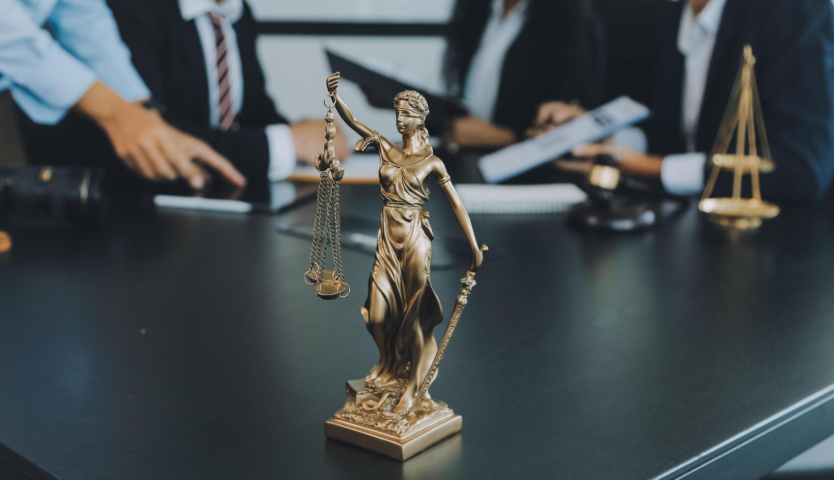 Judge gavel with Justice lawyers having team meeting at law firm background. Concepts of Law and Legal services. photo