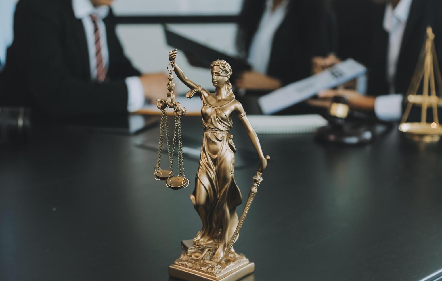 Judge gavel with Justice lawyers having team meeting at law firm background. Concepts of Law and Legal services. photo