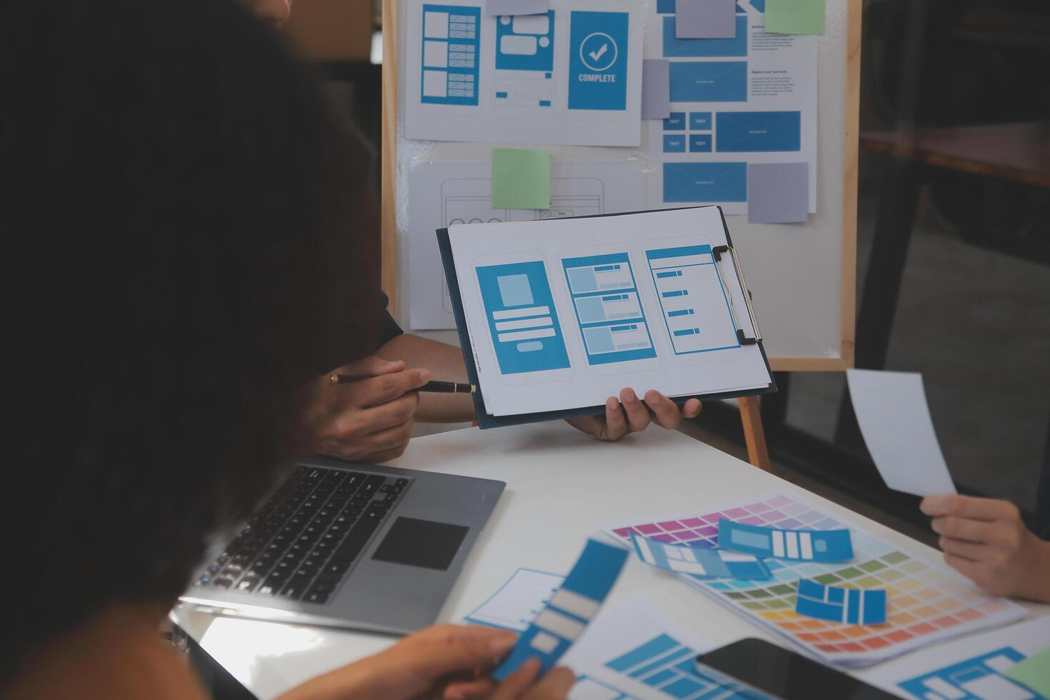 Close up ux developer and ui designer use augmented reality brainstorming about mobile app interface wireframe design on desk at modern office.Creative digital development agency photo