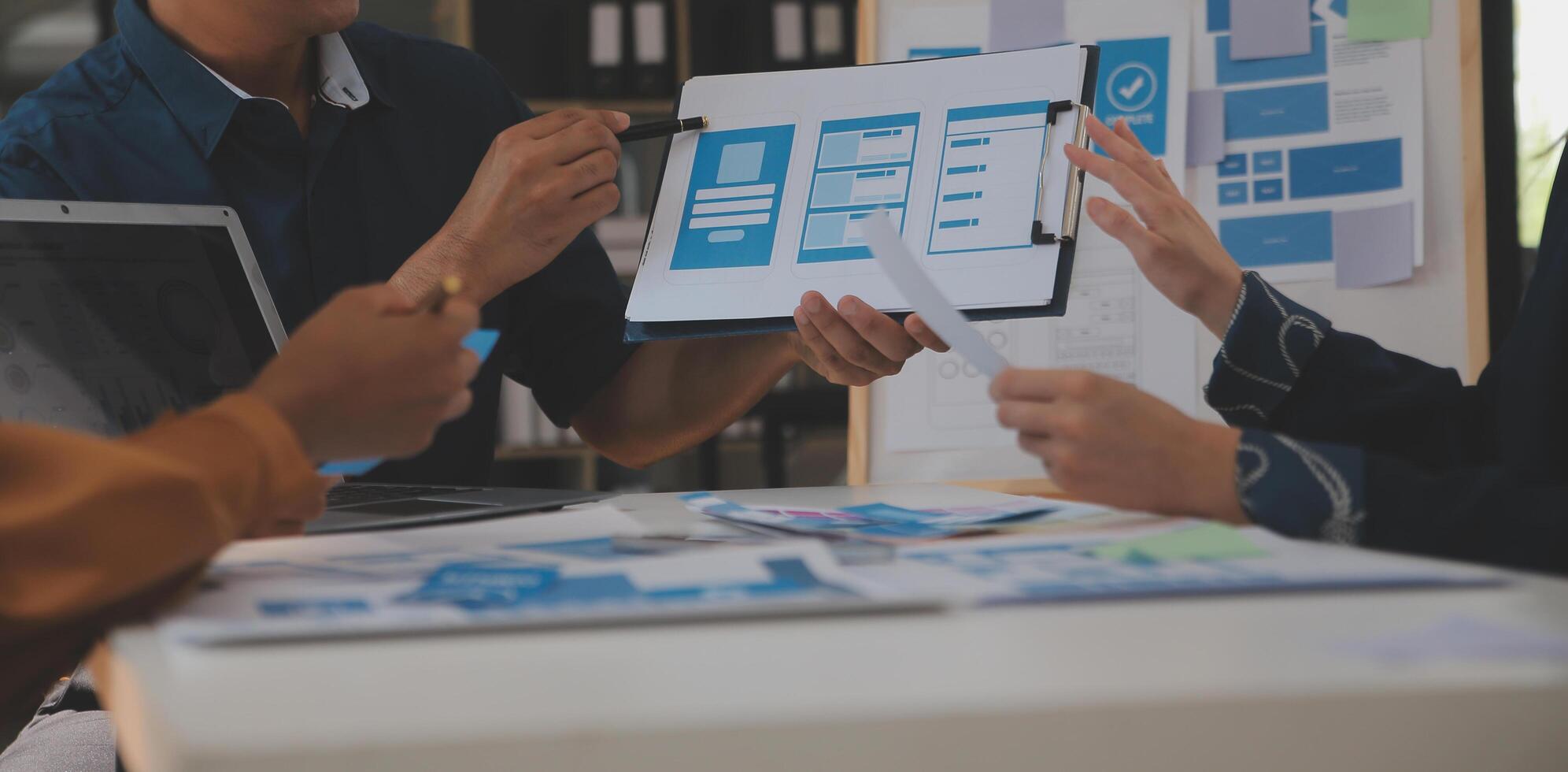 Close up ux developer and ui designer use augmented reality brainstorming about mobile app interface wireframe design on desk at modern office.Creative digital development agency photo