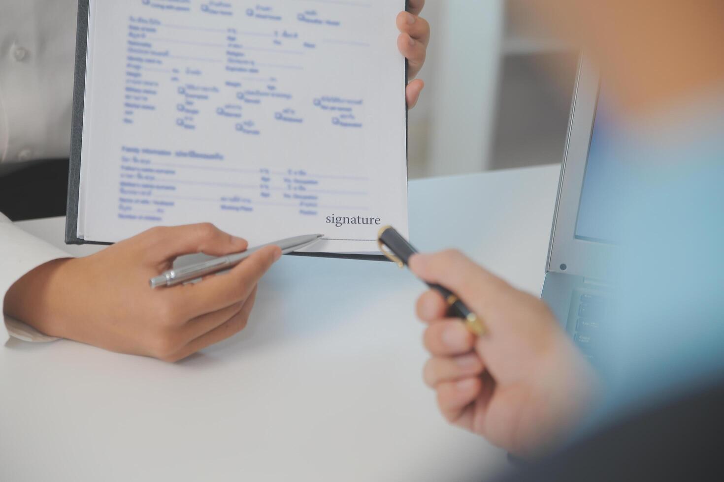 Close up view of job interview in office, focus on resume writing tips, employer reviewing good cv of prepared skilled applicant, recruiter considering application, hr manager making hiring decision photo