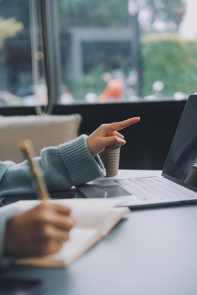 Confident female interpreter translate document from foreign language to english use pc app make notes in paper copy. Professional young woman editor correct errors mistakes in printed article text photo
