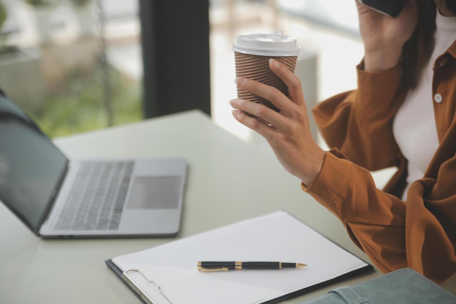 Asian businesswoman working on laptop computer Look for job online, freelance looking and typing on notebook on table, lifestyle of woman studying online photo