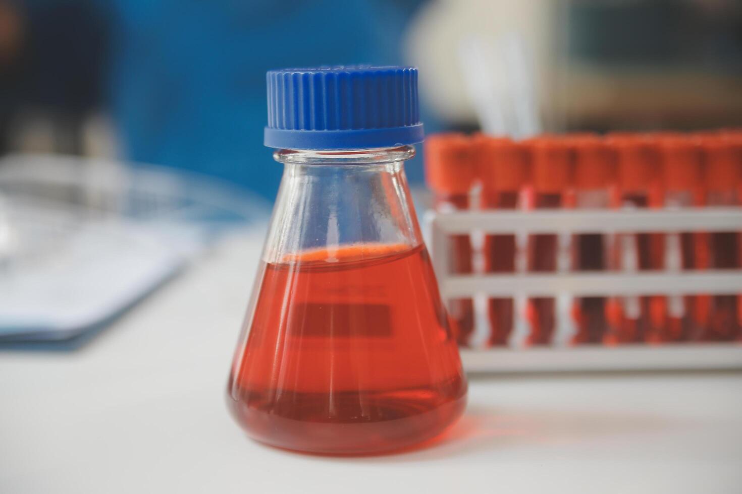 biochemical research scientist team working with microscope for coronavirus vaccine development in pharmaceutical research labolatory, selective focus photo