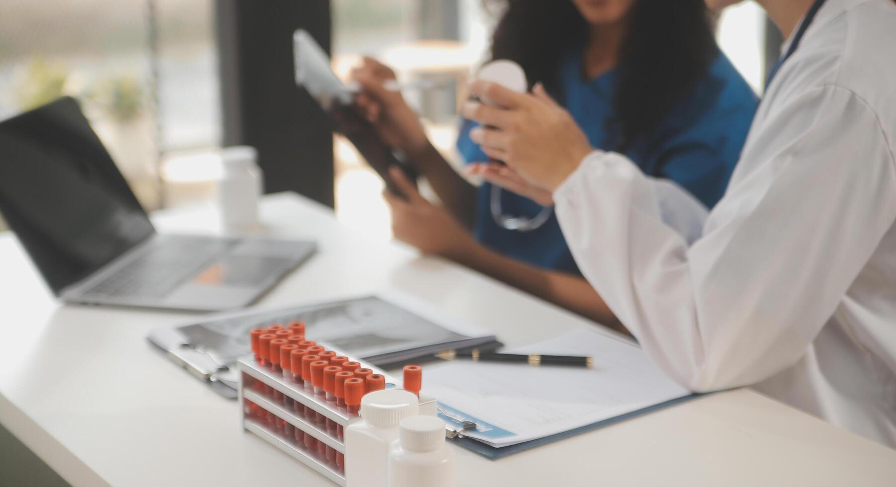 biochemical research scientist team working with microscope for coronavirus vaccine development in pharmaceutical research labolatory, selective focus photo