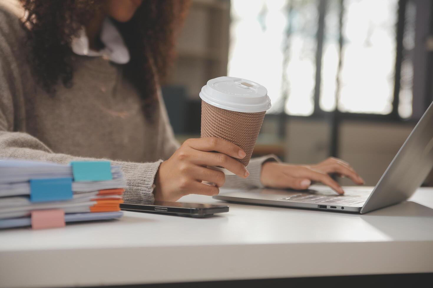 Asian businesswoman working on laptop computer Look for job online, freelance looking and typing on notebook on table, lifestyle of woman studying online photo