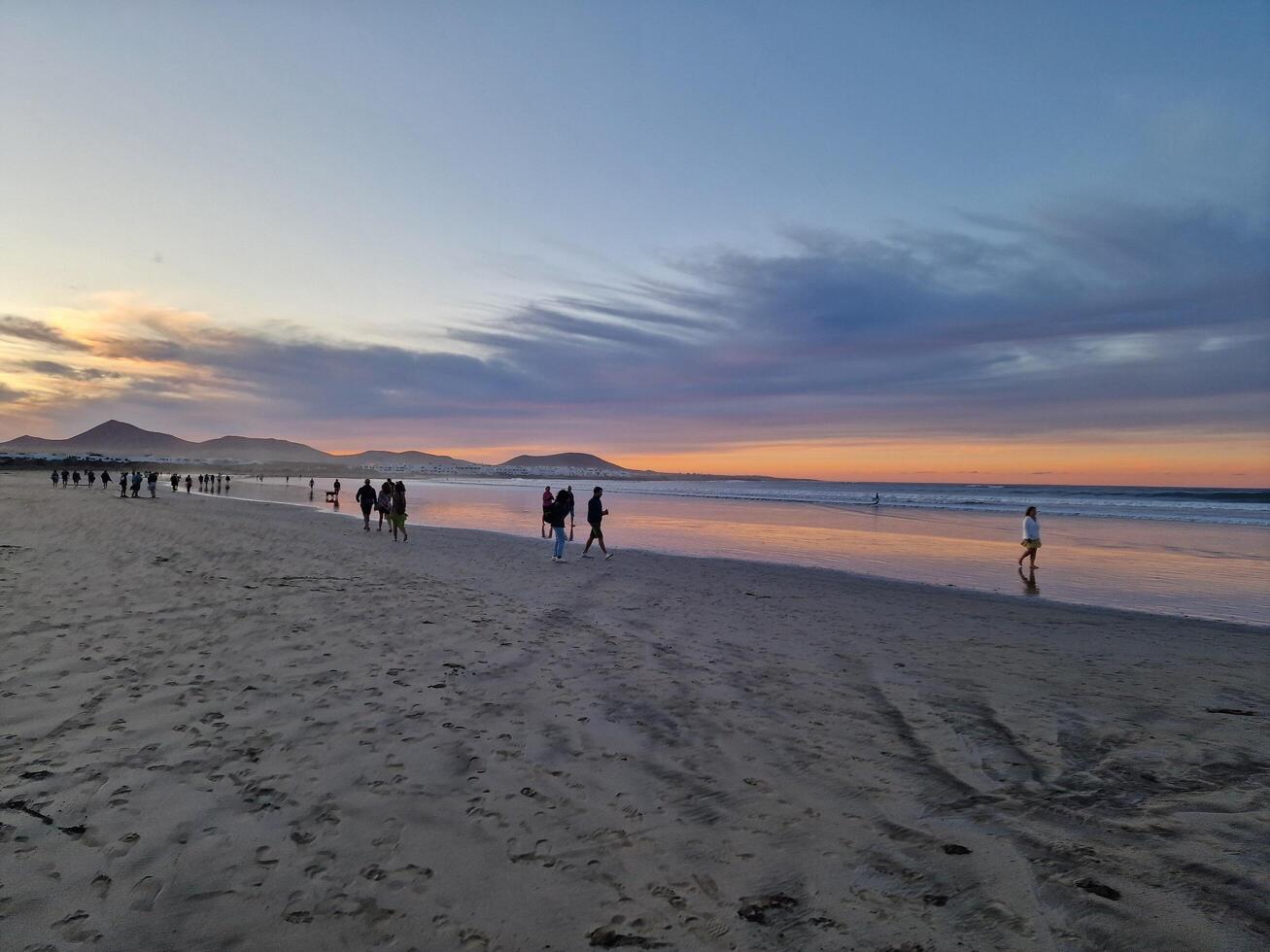 puesta de sol en famara playa en lanzarote isla foto