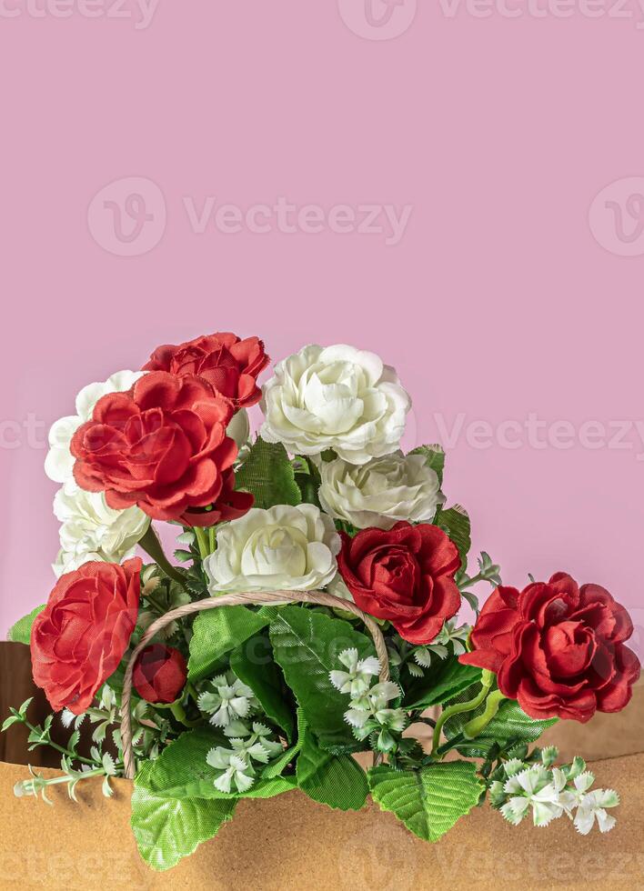 Bouquet of red and white roses on a pink background with copy space for your text. photo