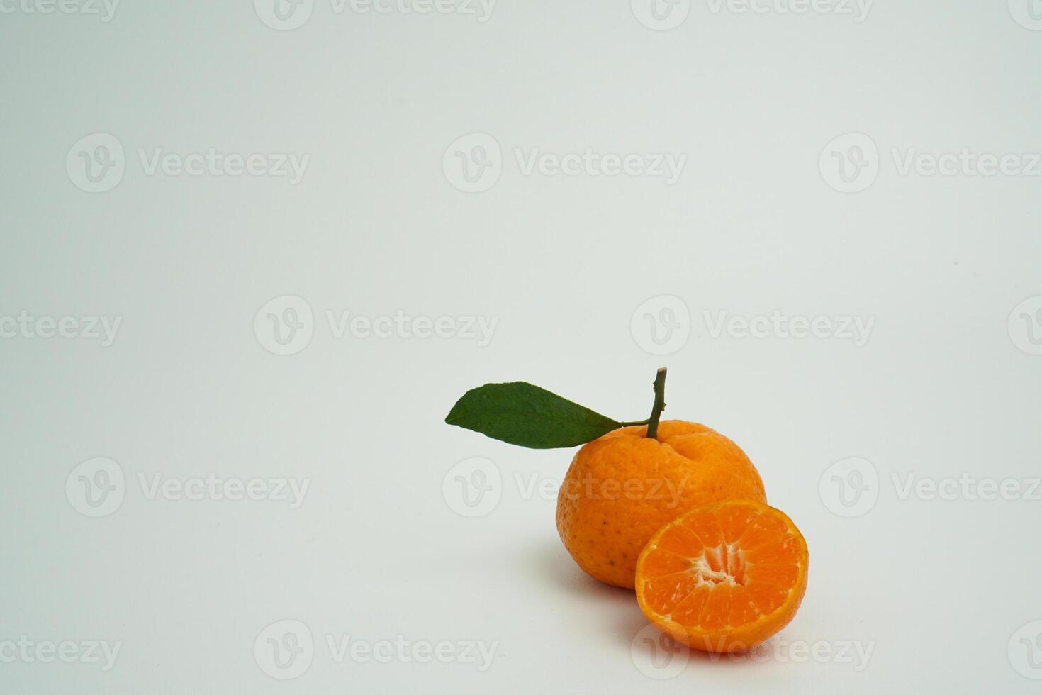 copy space of isolated fresh half and whole orange fruit on white background photo