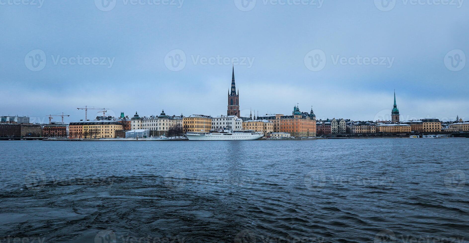 Aerial View of Large Body of Water With Buildings in Background photo