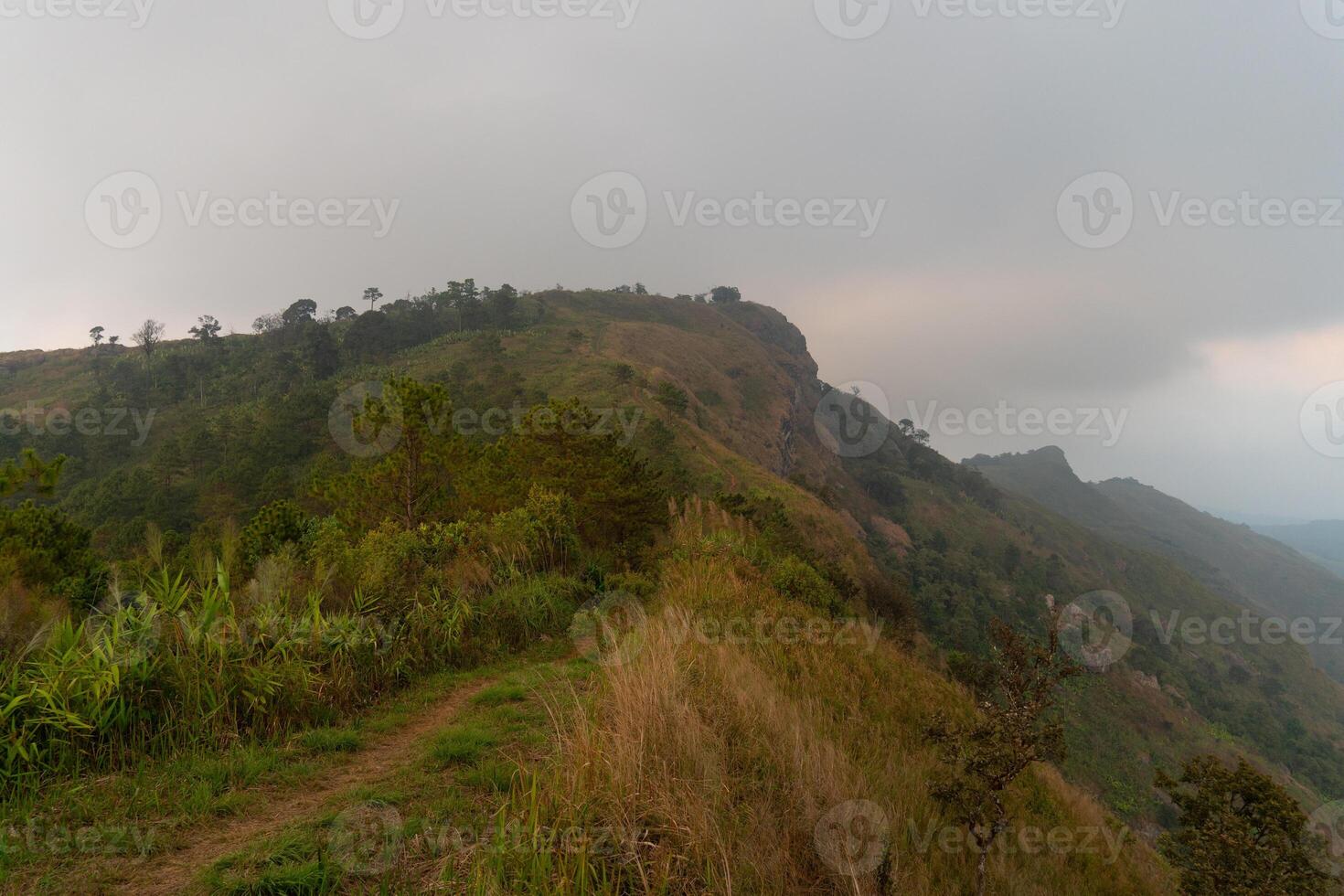 Landscape view to mountain peak. Route heads to the mountaintop view point Phu Langka. Faint background image of distant mountains in the mist. At Phu Langka Phayao Province of Thailand. photo