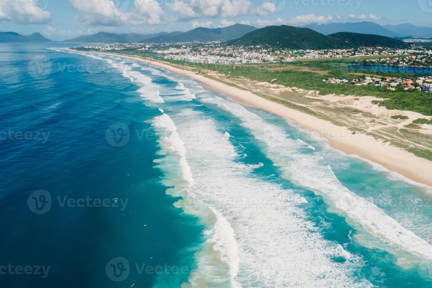 Beach and ocean with surfing waves in Brazil. Aerial view of Campeche beach photo