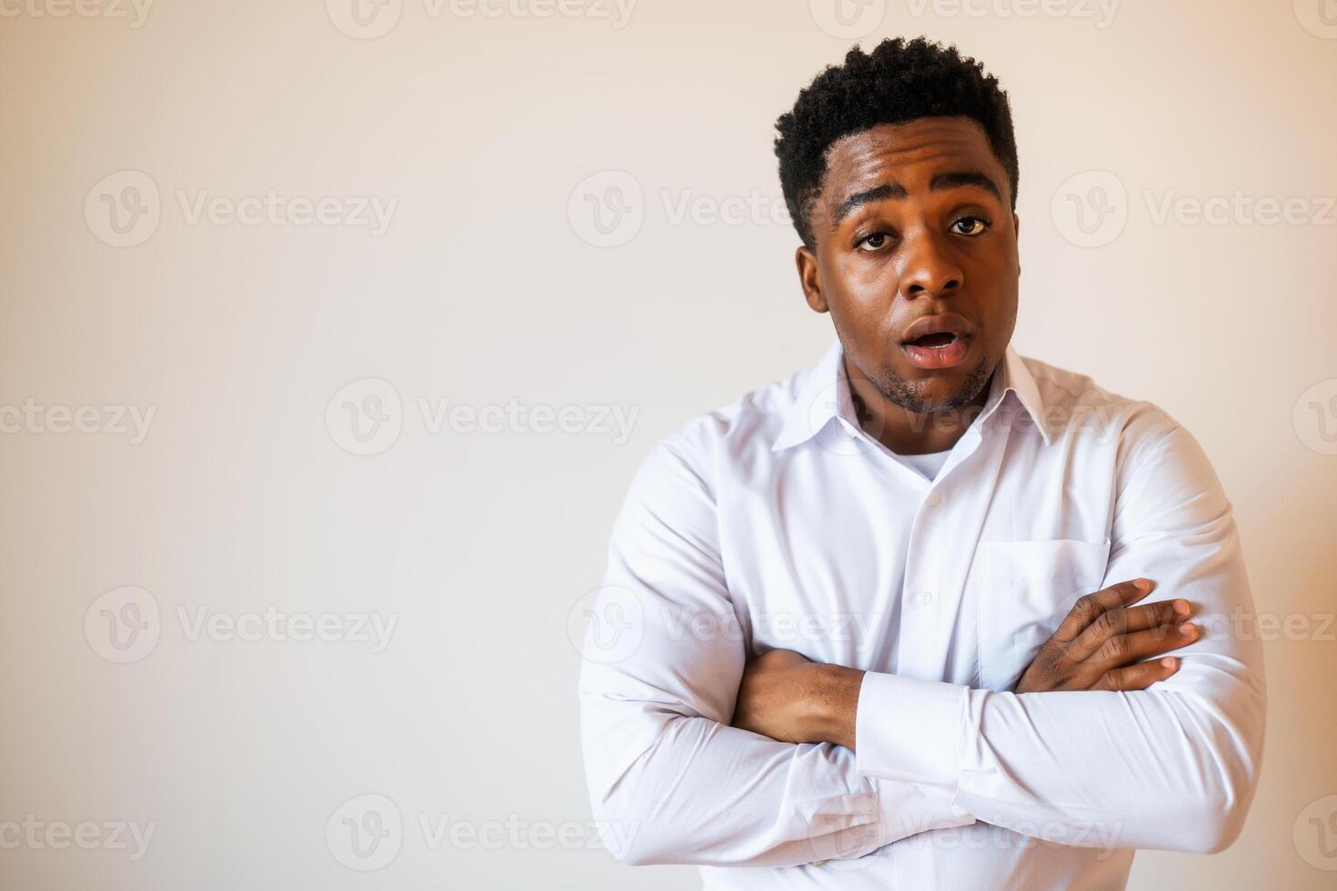 Portrait of young businessman who is shocked. photo