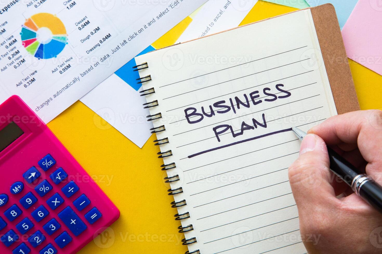 Business plan written on notepad with graph analysis background. Business Plan Concept photo