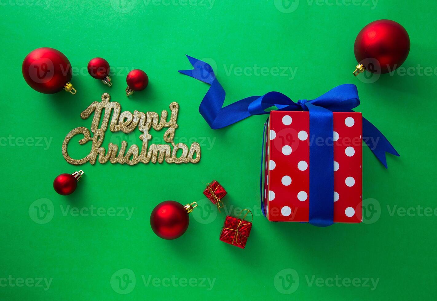 Gift boxes and Christmas decorations on green background photo