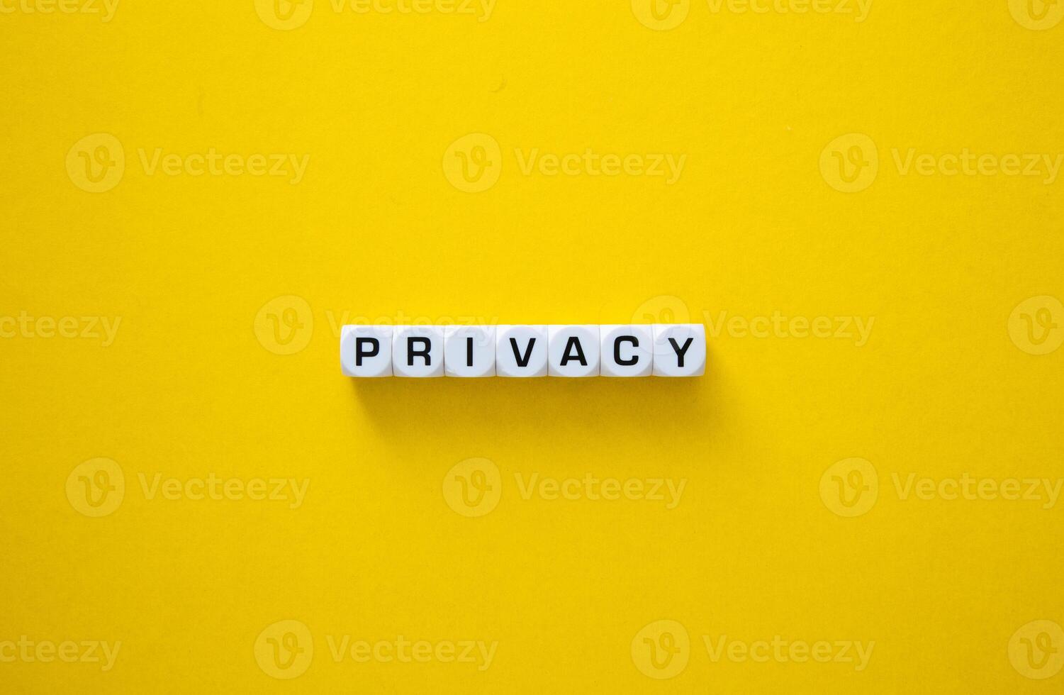 Privacy word on yellow background photo