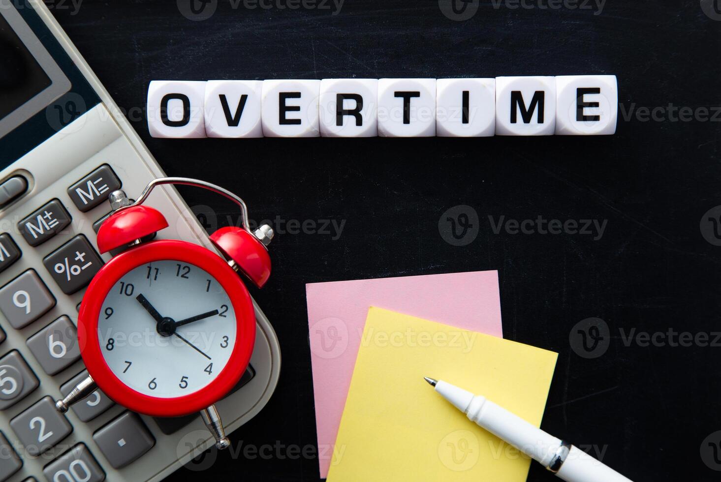 Clock, Calculator and Overtime Word on black background. photo