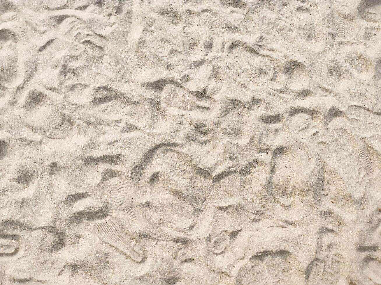 Fine sand with many foot step on beach photo