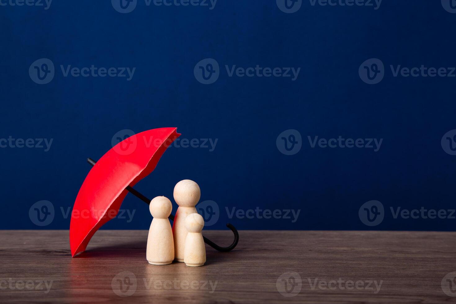 Umbrella and wooden doll figures. photo