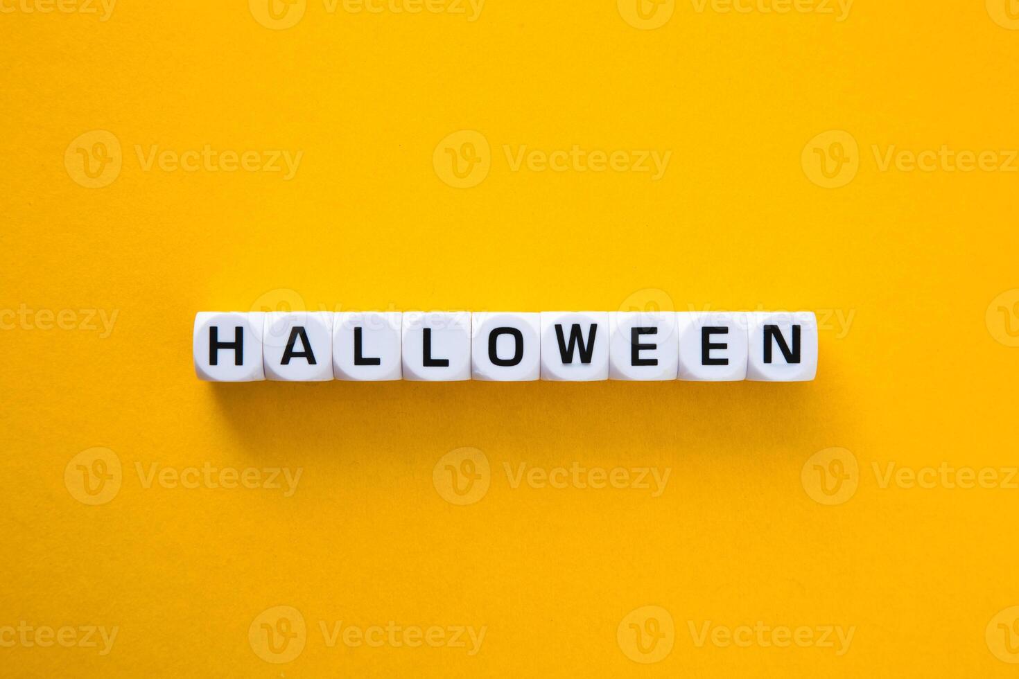 Halloween word on a yellow background. photo