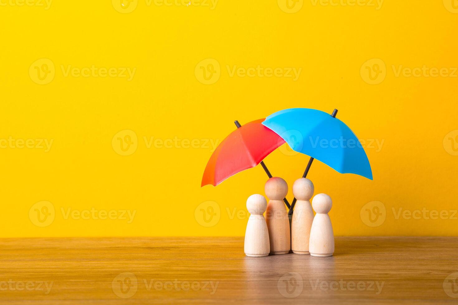 Umbrella and wooden doll figures. photo