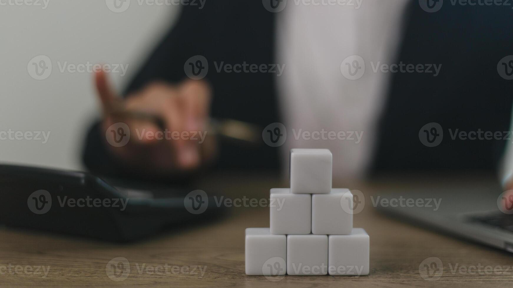Businesswomen stack blank wooden cubes on the table with copy space, empty wooden cubes for input wording, and an infographic icon photo