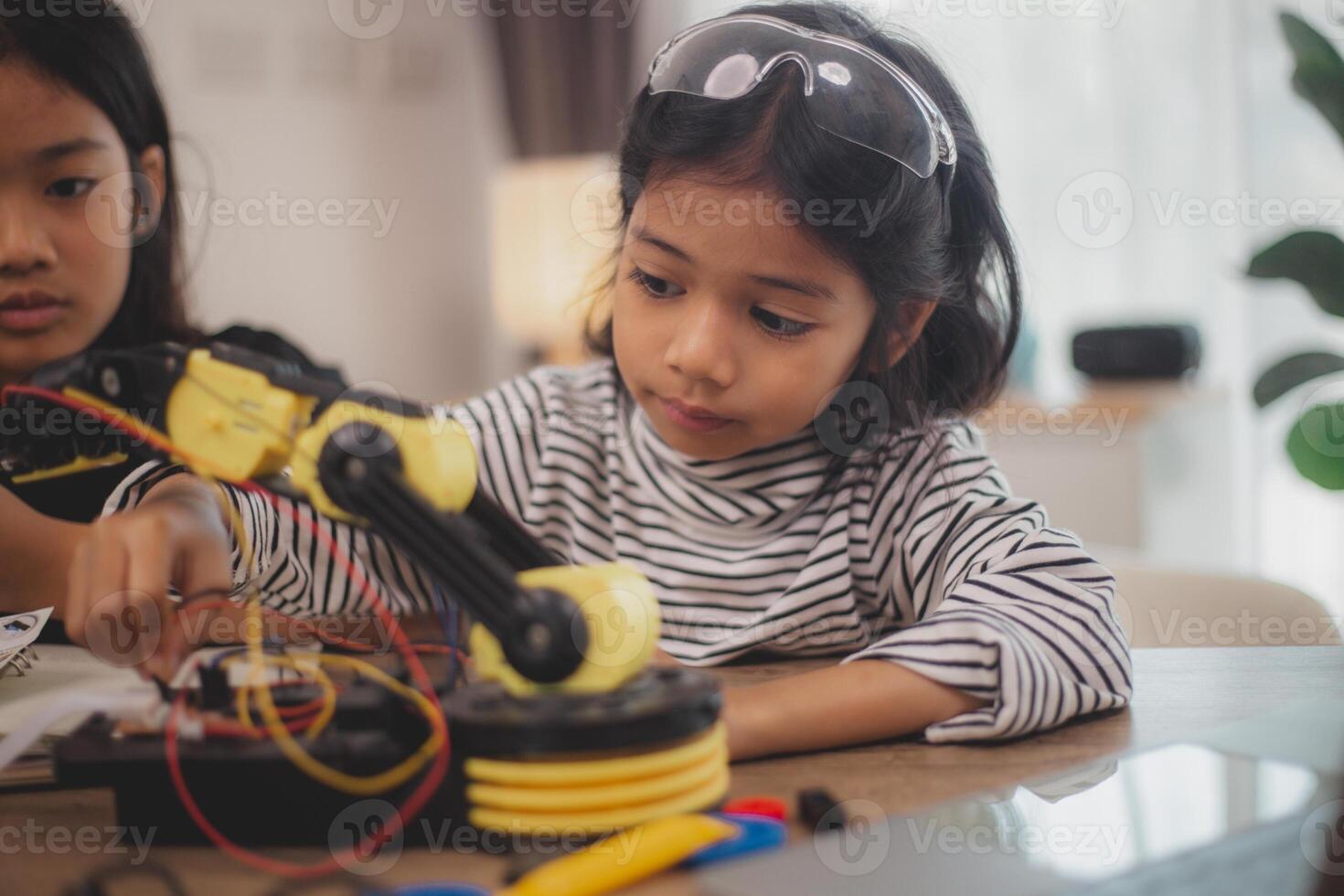 Asian students enjoy Machine Learning Robot arms Control robots in technology class, stem education robot arms for digital automation software for artificial intelligence AI. STEM education concept. photo
